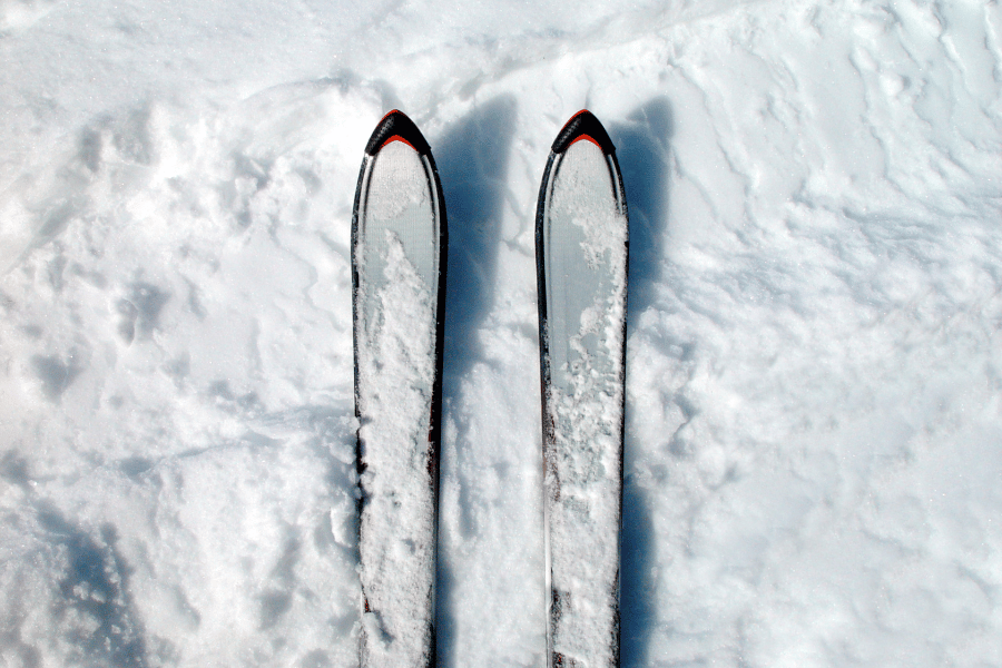 New pair of skis in the fresh white snow 