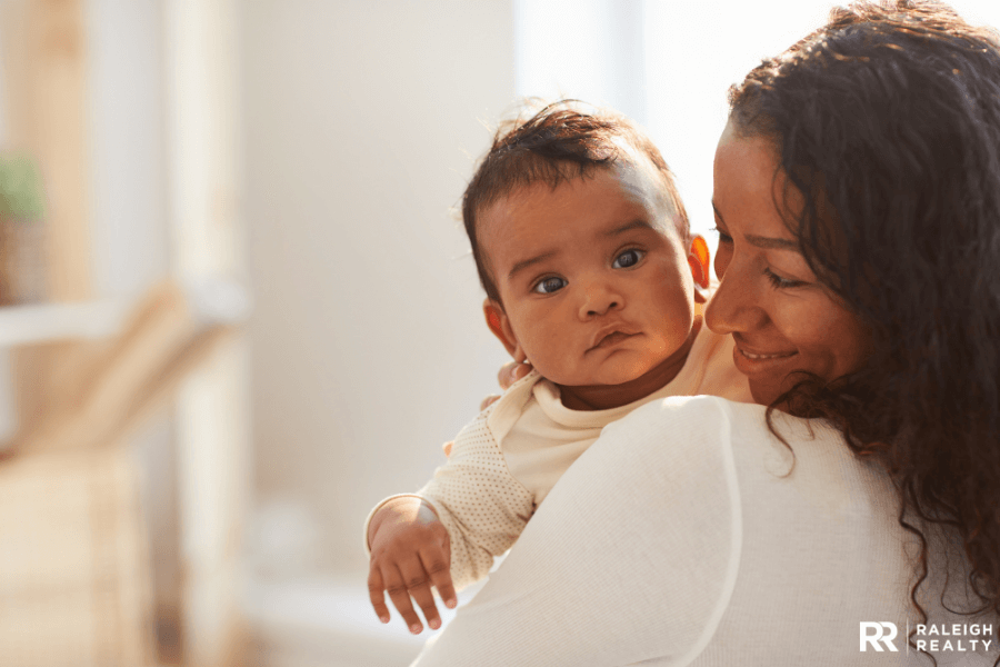 A beautiful baby being held by his single mother