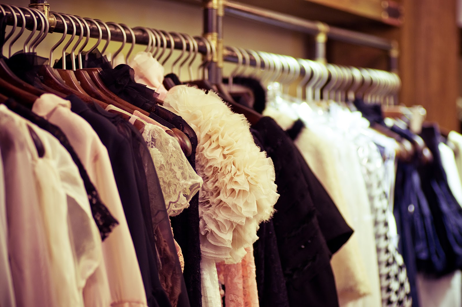 Fashionable clothes hanging in a closet.