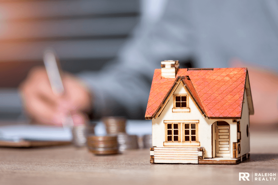 Large image of house with coins and money in the background 