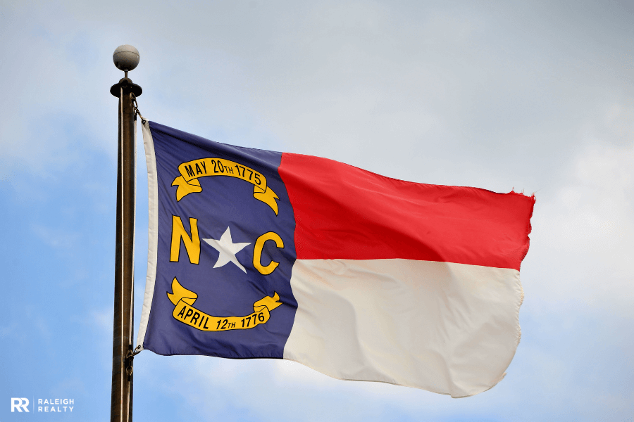 North Carolina State Flag blowing in the wind with a flag pole