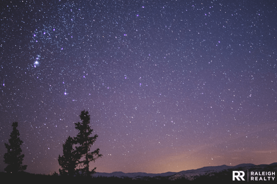 The stars and mountains at night time with very little light and a clear sky