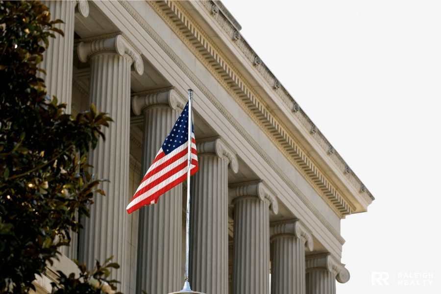 United States Flag in the foreground with a government building in the background
