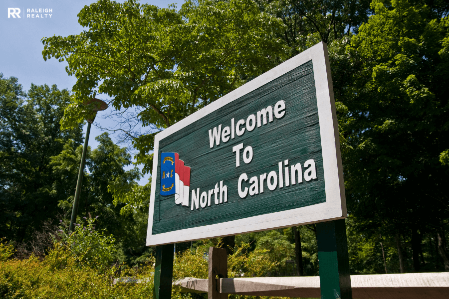 Green sign that reads welcome to north carolina and welcoming folks coming to Wendell