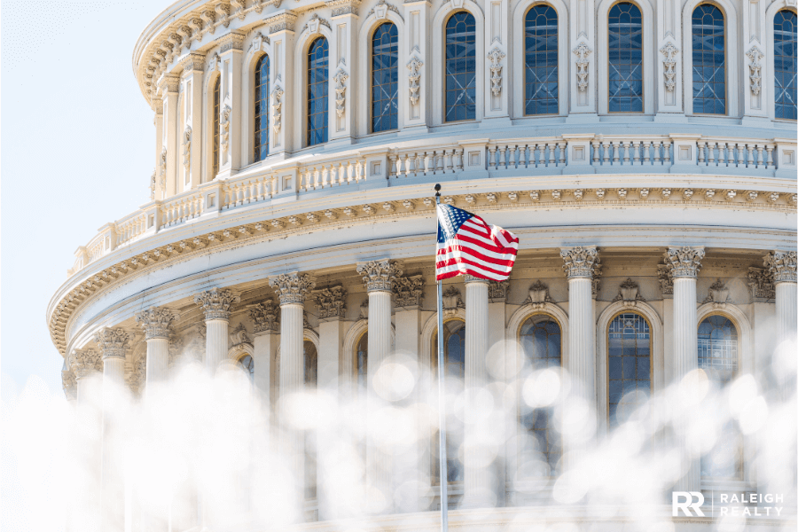 A Government Building with a beautiful united states flag blowing in the wind