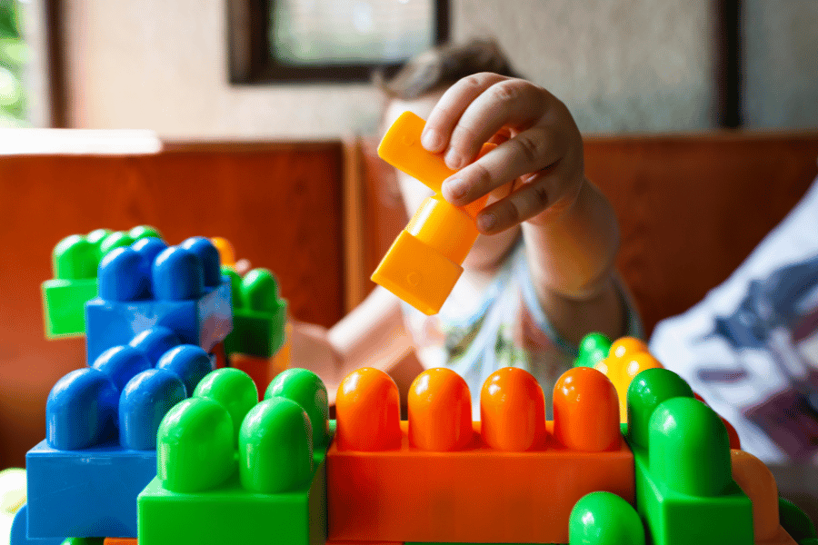 child playing with colorful toys at daycare 