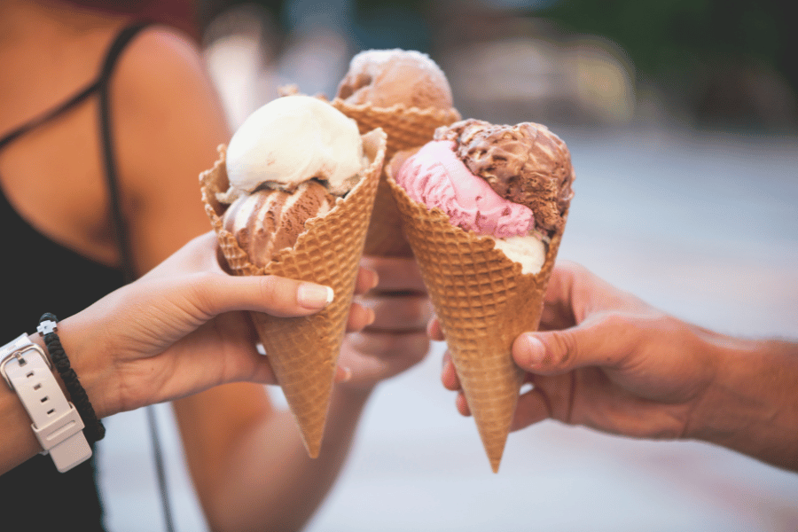 Three ice cream cones with scoops of ice cream 