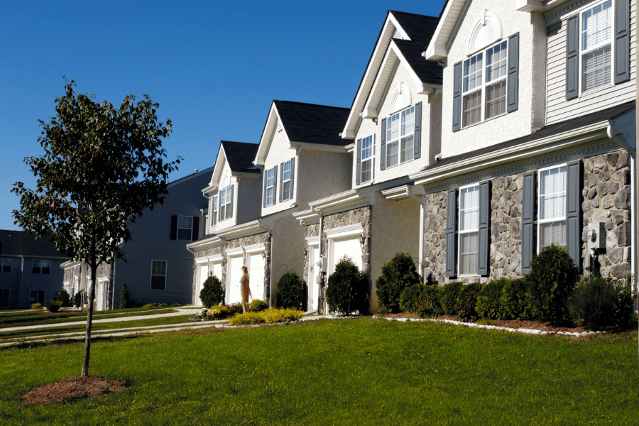 Pretty condos in the suburbs with stone siding and garages