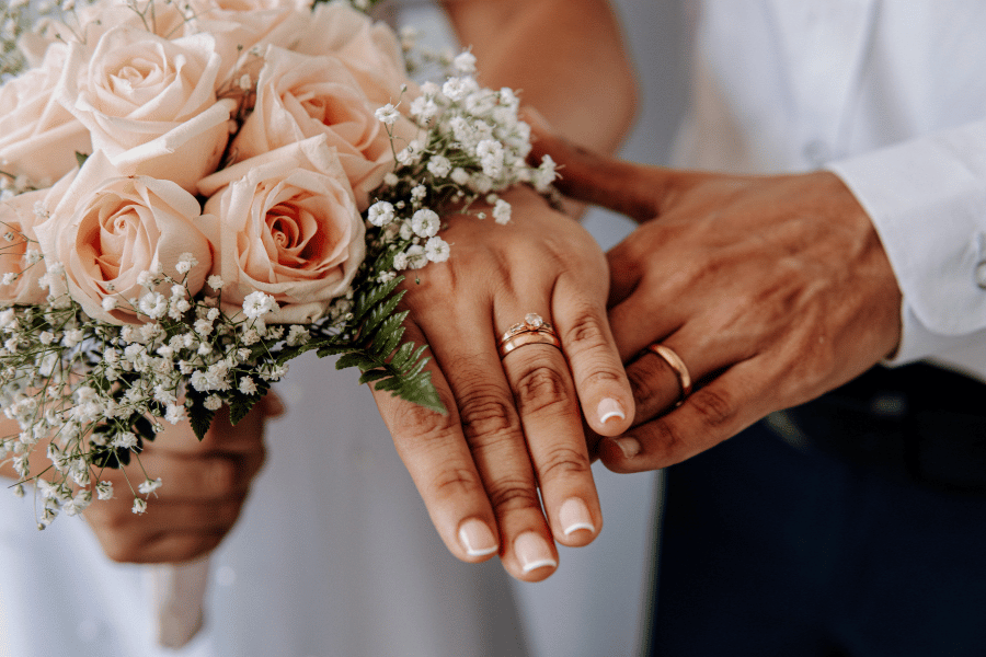 bride and groom wearing wedding rings 