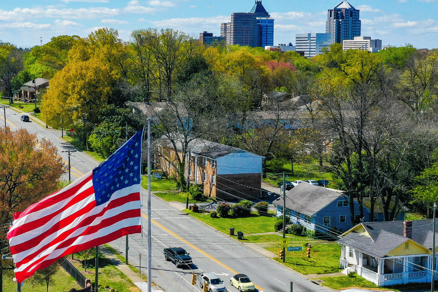 Street view outside downtown NC with homes and flag