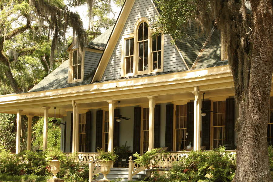 beautiful historic home with front porch and large shaded trees