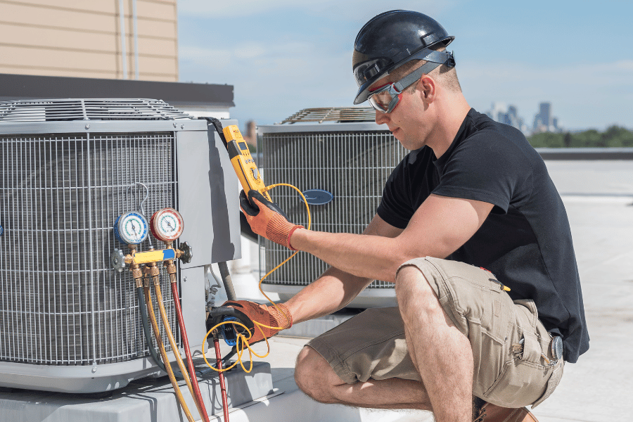 Repairing an HVAC system with professional on roof