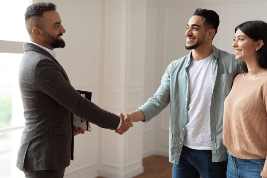 Millennial shaking hand with trustworthy agent