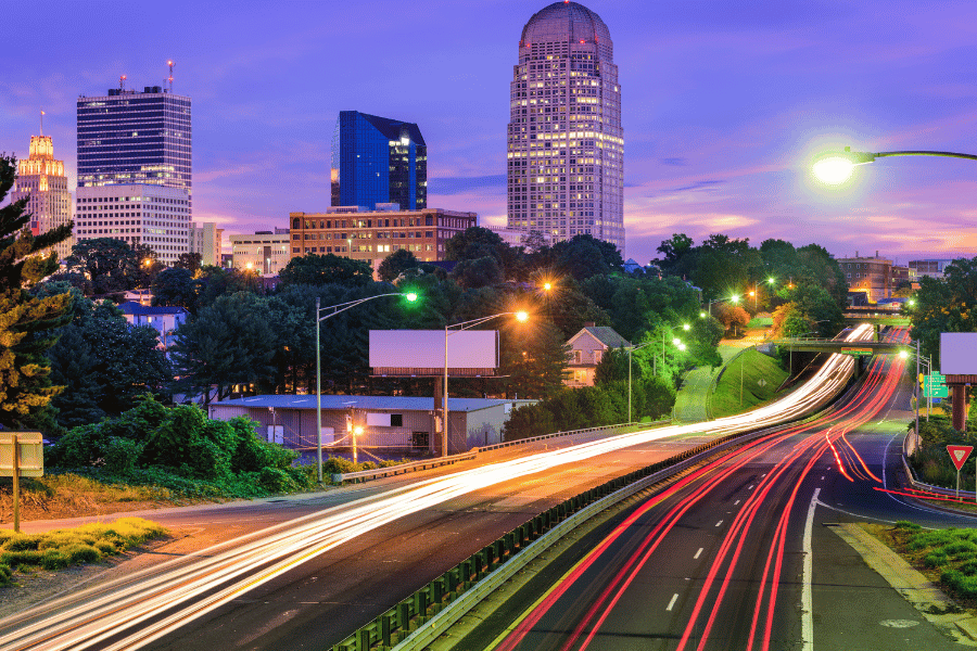 Driving into downtown Raleigh at night time with the car lights