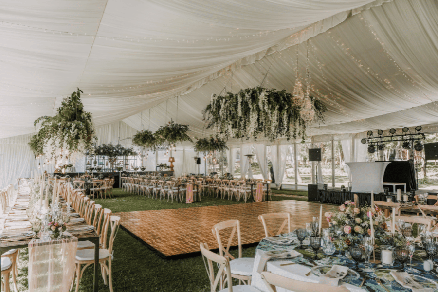 wedding reception with decorated tables and a dance floor 