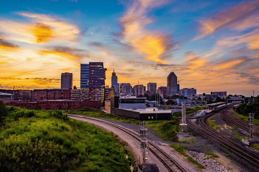 Downtown Raleigh skyline during sunset near the train tracks