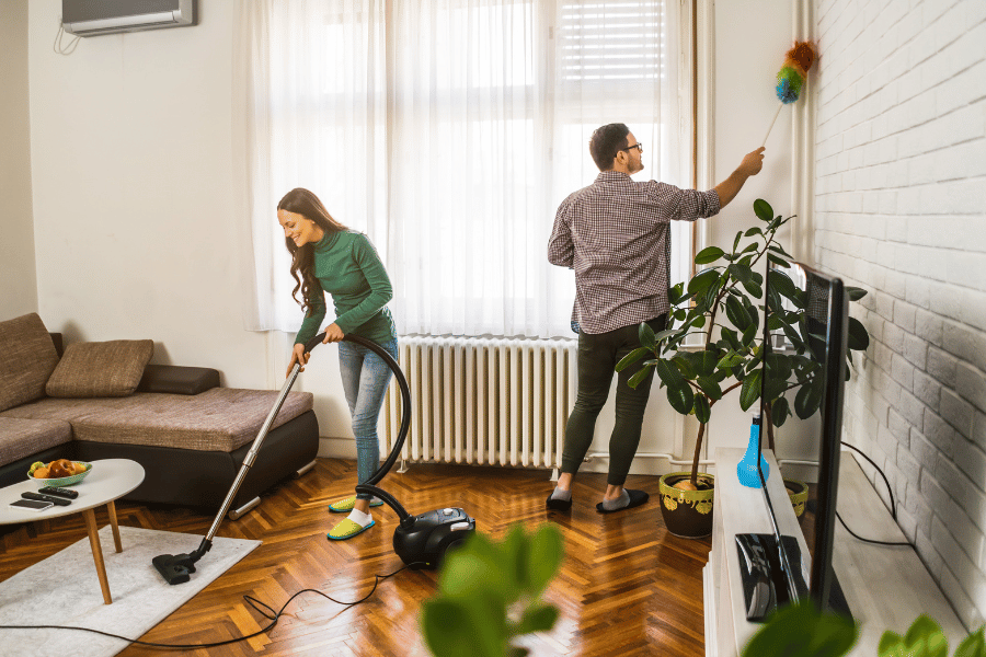 two people cleaning their home