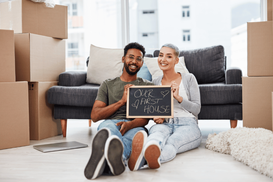 couple buying a home and moving in with boxes