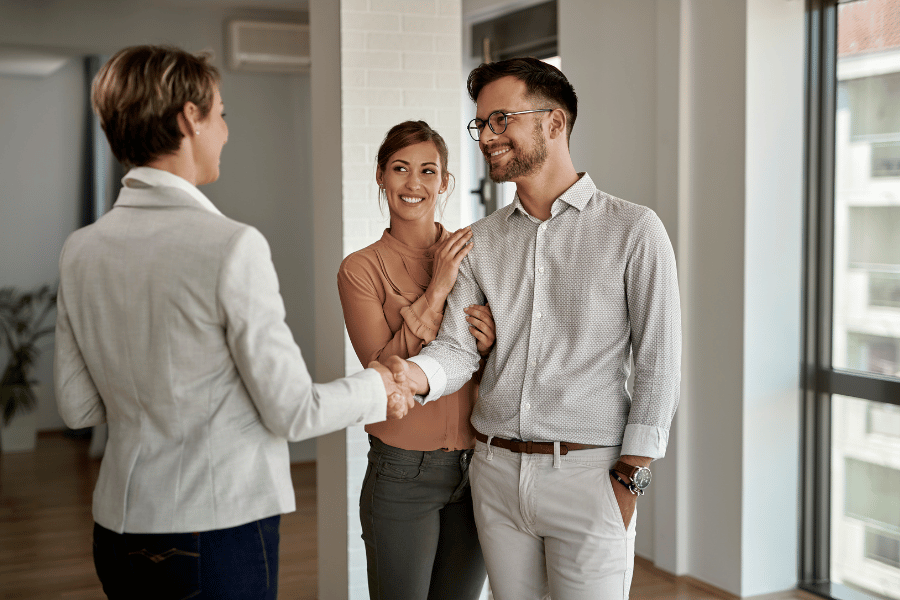 couple meeting a real estate agent who will help sell a home