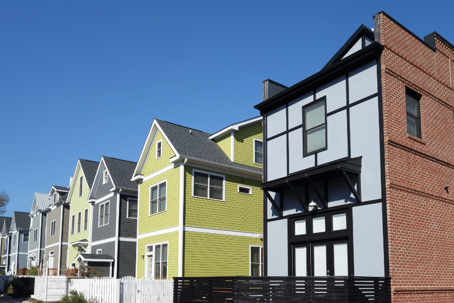 colorful homes in Downtown Raleigh with fences on a clear day