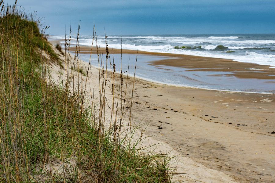 Beach view of the water and sand dunes in the OBX