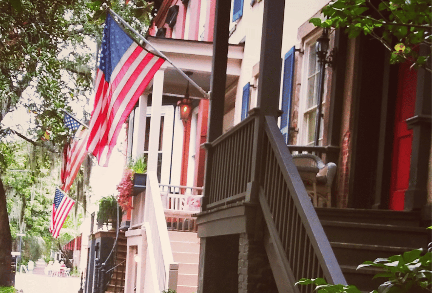 Street of homes in Savannah GA with flags hanging