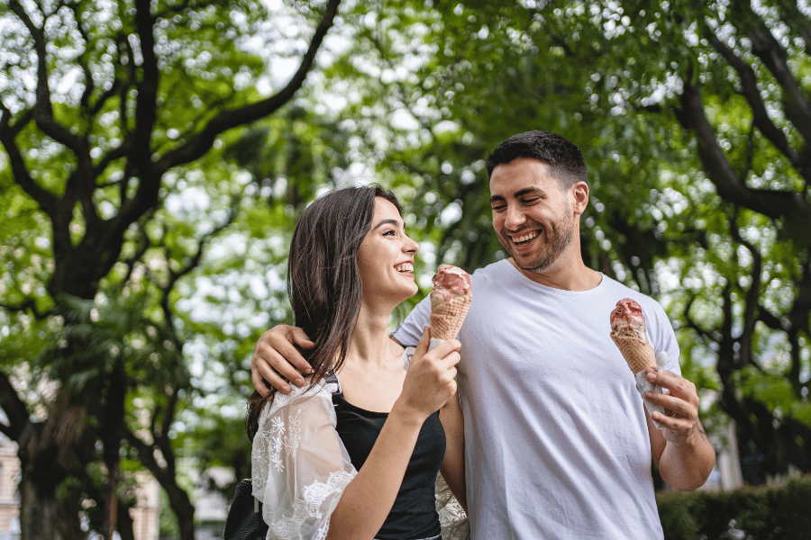 cute couple on an ice cream date eating waffle cones