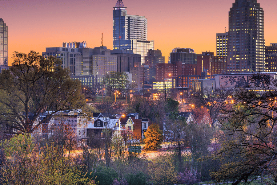 Downtown view of Raleigh NC with houses and sunset