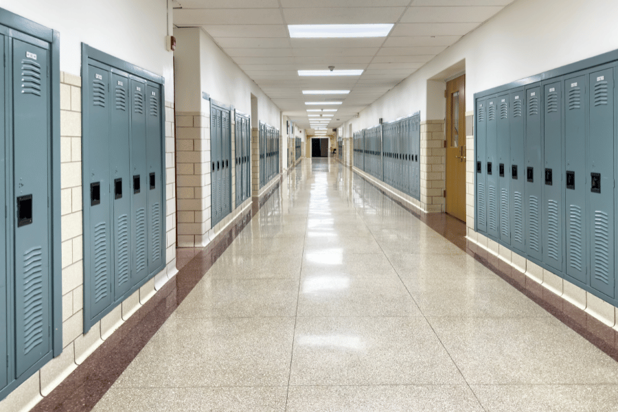 school corridor with blue lockers and tile floors 