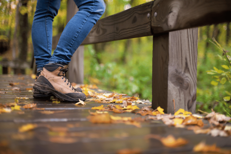 hiking on a trail in the woods with fall leaves 