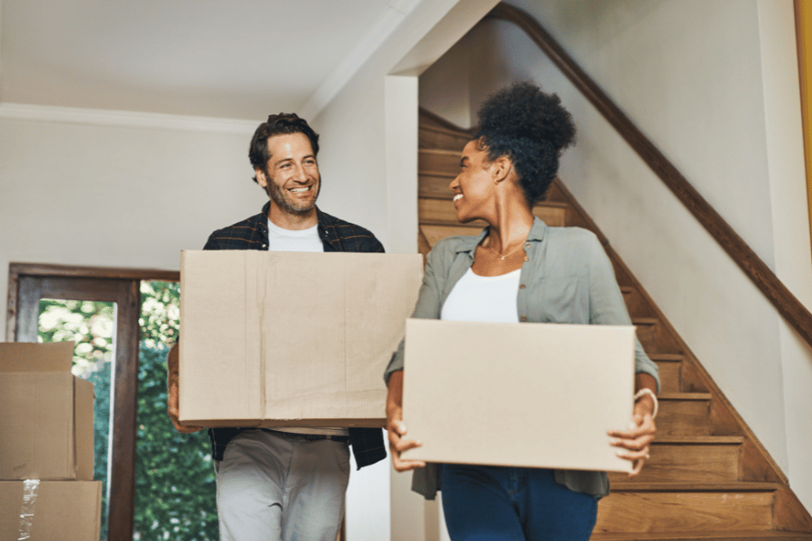 cute couple of first time homebuyers moving into new home