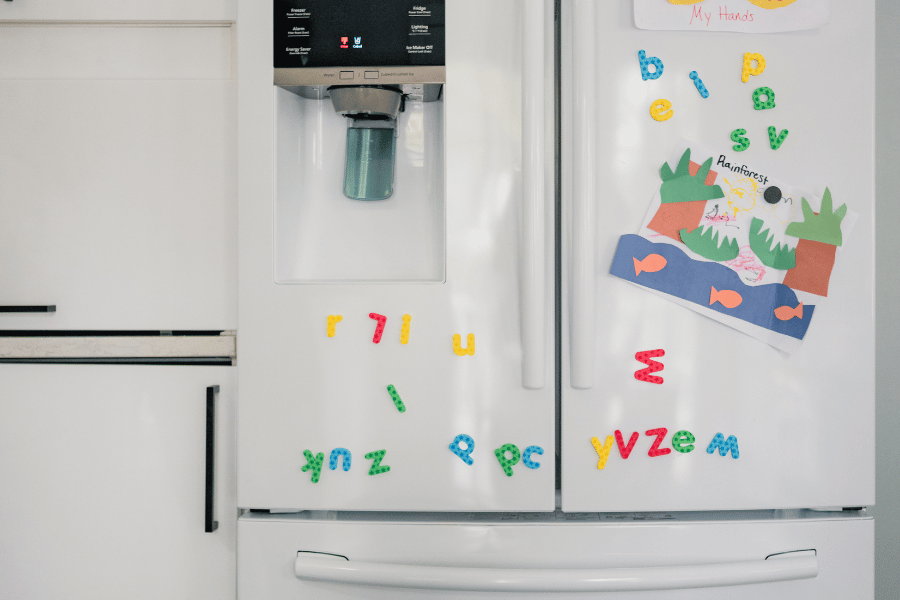 kids artwork hung up on a family fridge 