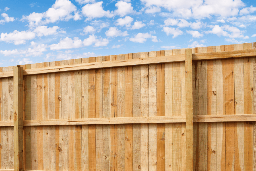 Tall wooden privacy fence example in backyard