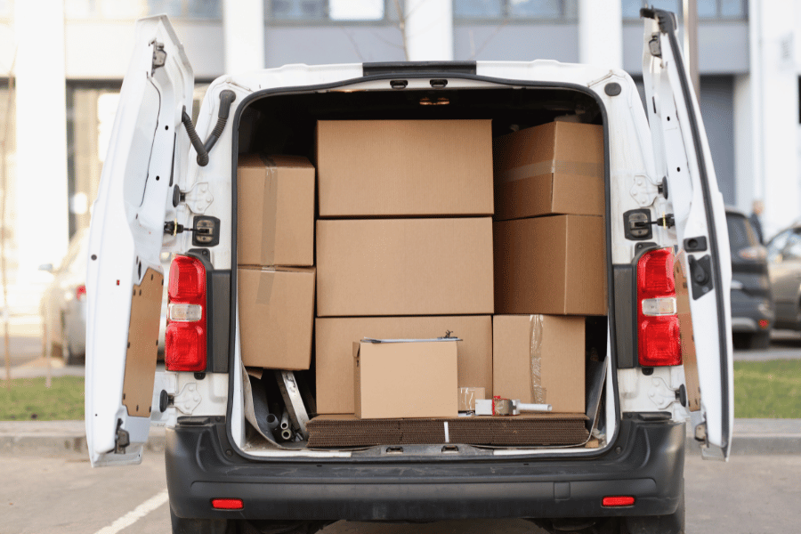packing boxes piled into white truck during a move