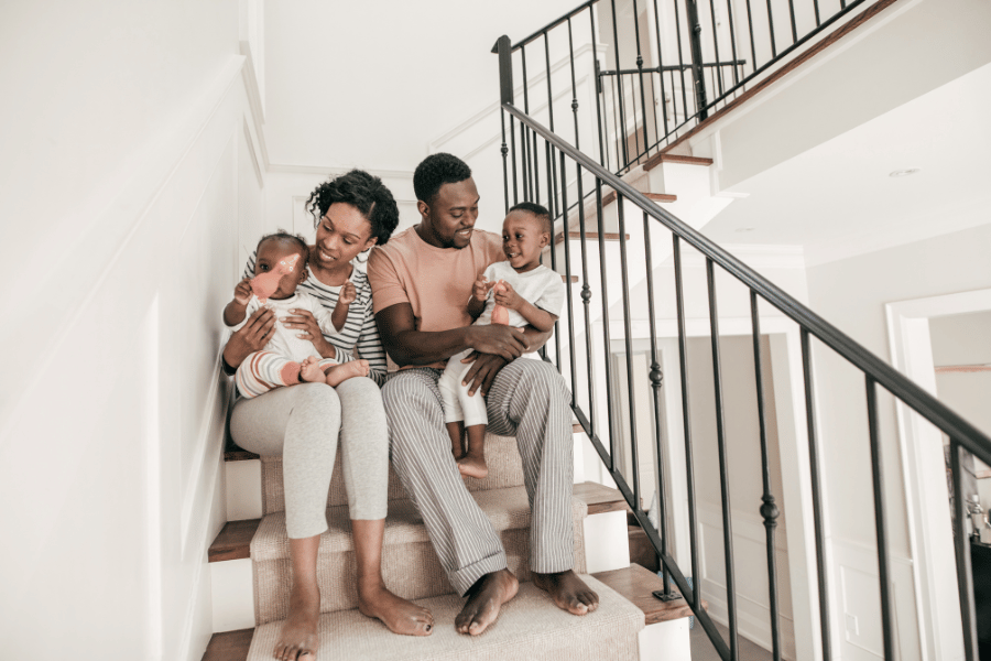 cute family in new home sitting on the steps 