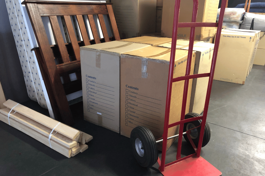 packing boxes and a hand truck ready for moving day