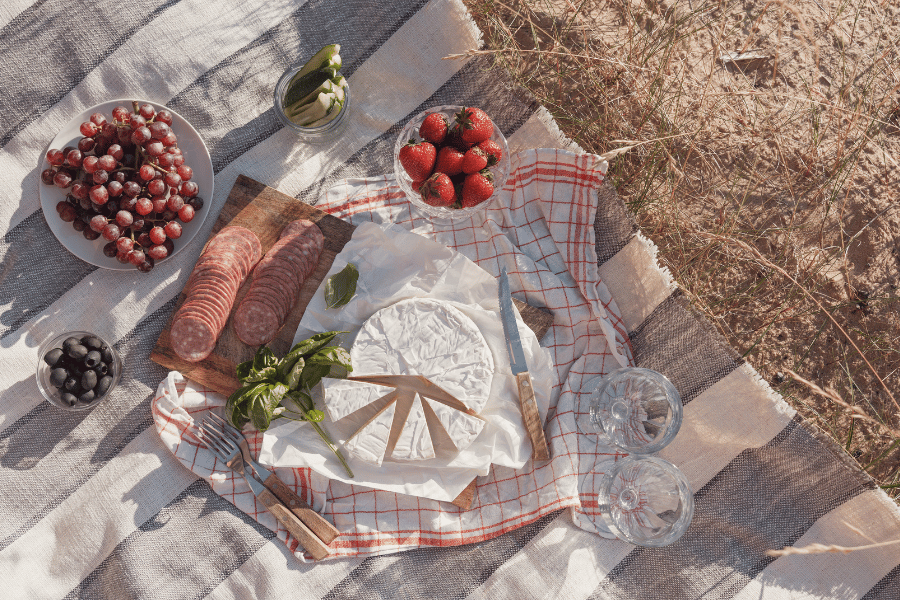 cute picnic in the park with fresh fruit and cheese 