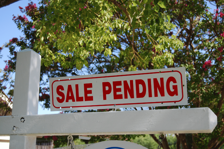 sale pending real estate sign in front yard