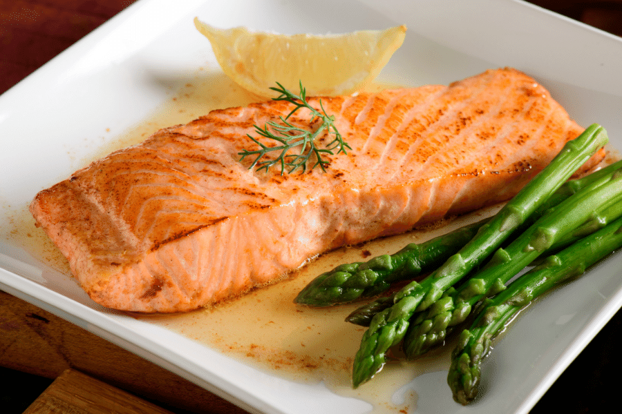 white plate with salmon and asparagus 