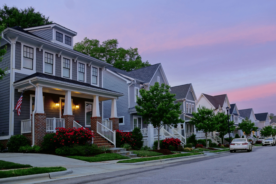 quiet Raleigh street lined with beautiful homes with front porches during sunset