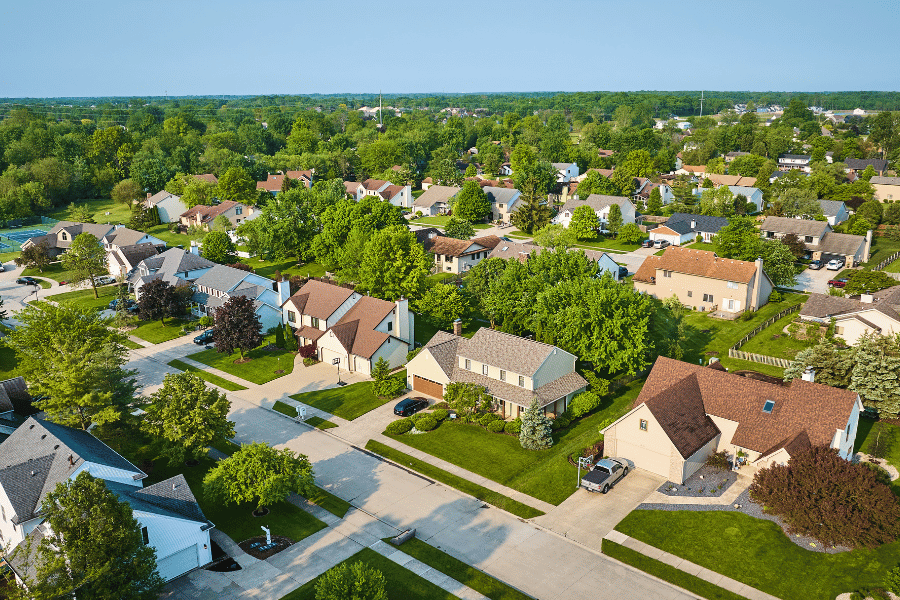 Suburban neighborhood view with greenery and large single-family homes