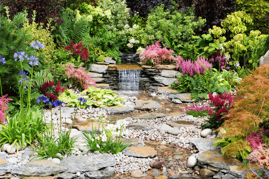 beautiful water feature in the colorful backyard garden