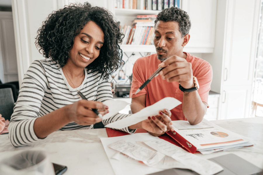 couple completing taxes at the kitchen table in their home