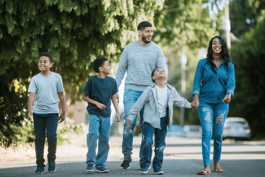 family of five going on a walk throughout the neighborhood