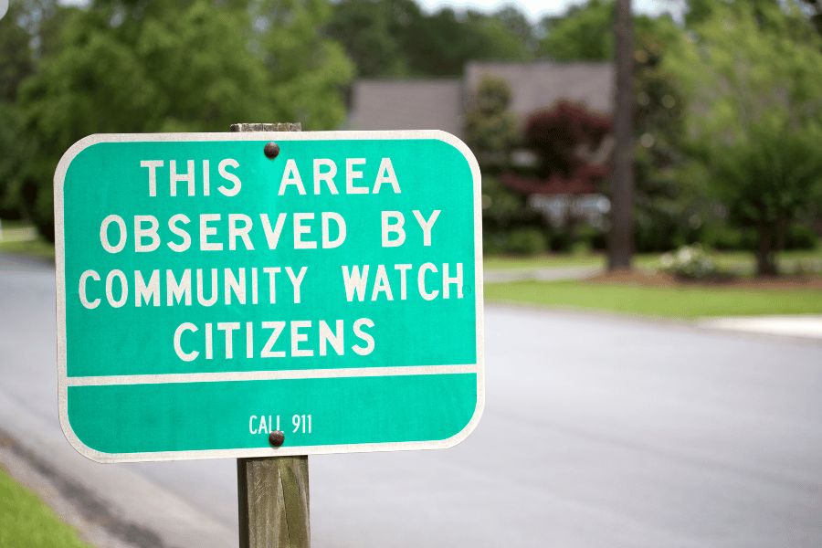 green community watch sign in a neighborhood