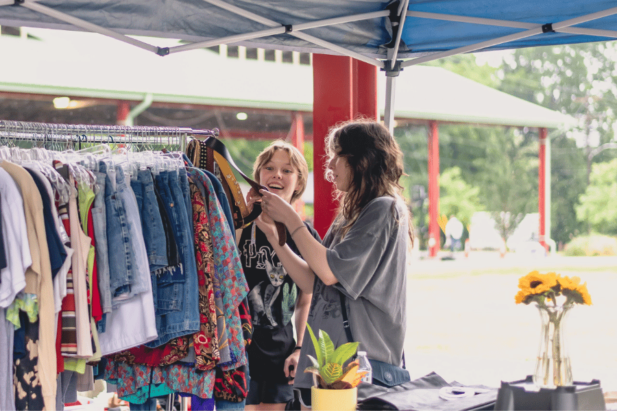 women looking through clothes at vintage bazarre