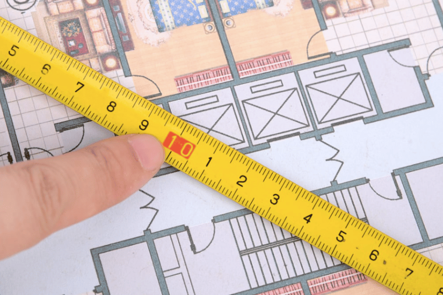Measuring floor plan with measuring tape 