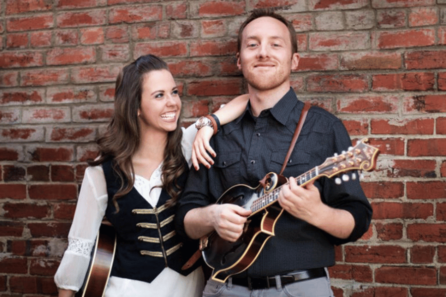 Sierra Hull and Justin Moses next to a brick wall