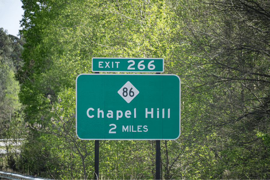 Chapel Hill, NC green road sign surrounded by trees