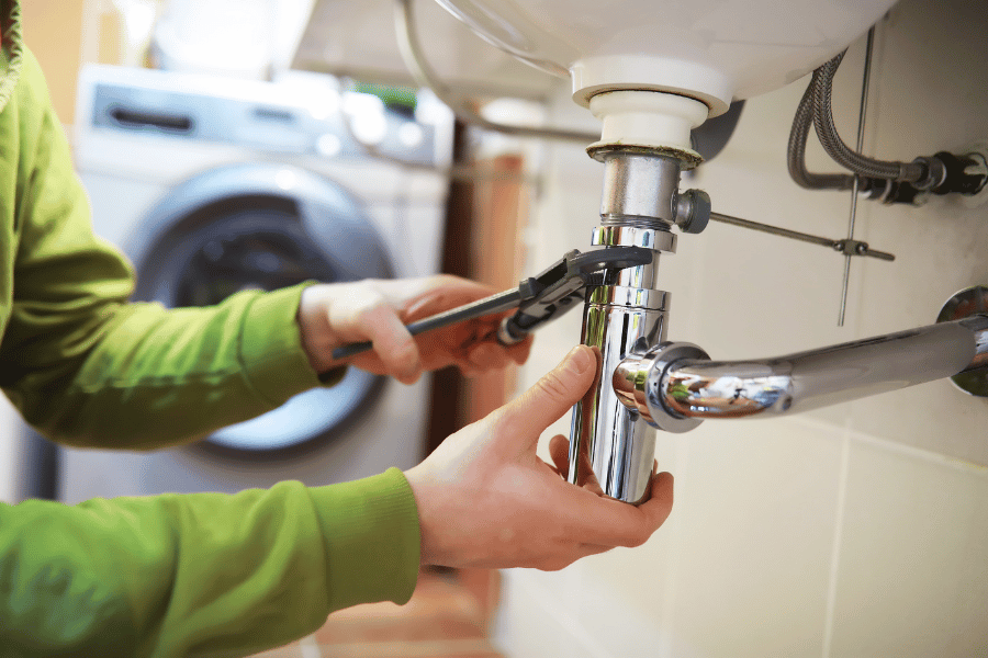 homeowner fixing the sink and making other home repairs